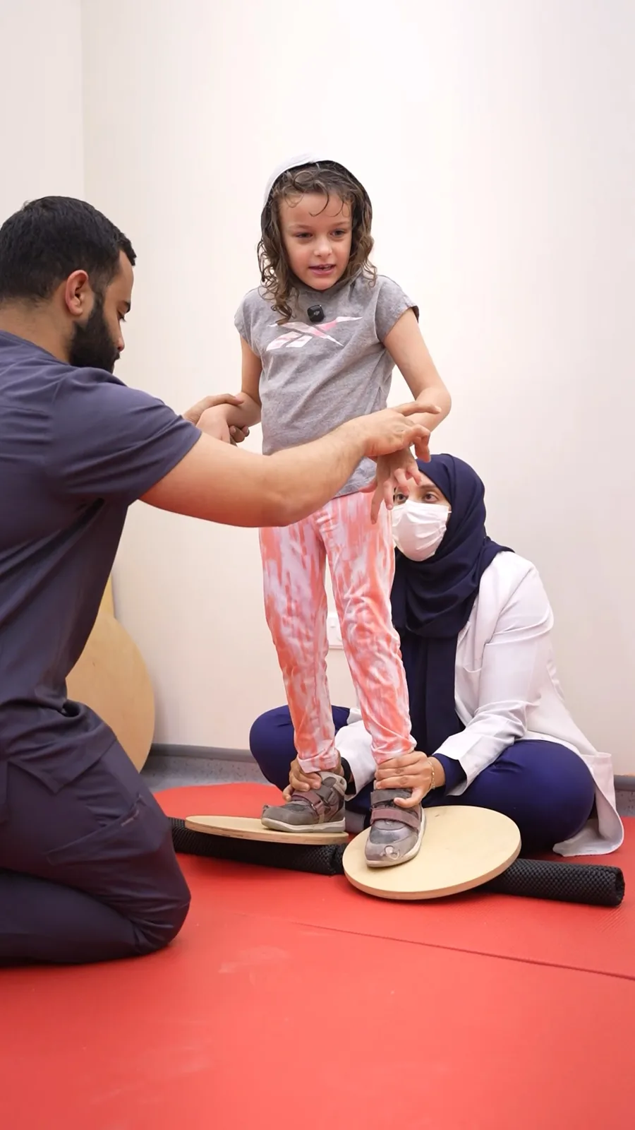 A Hope therapist supporting a child as they practice standing balance