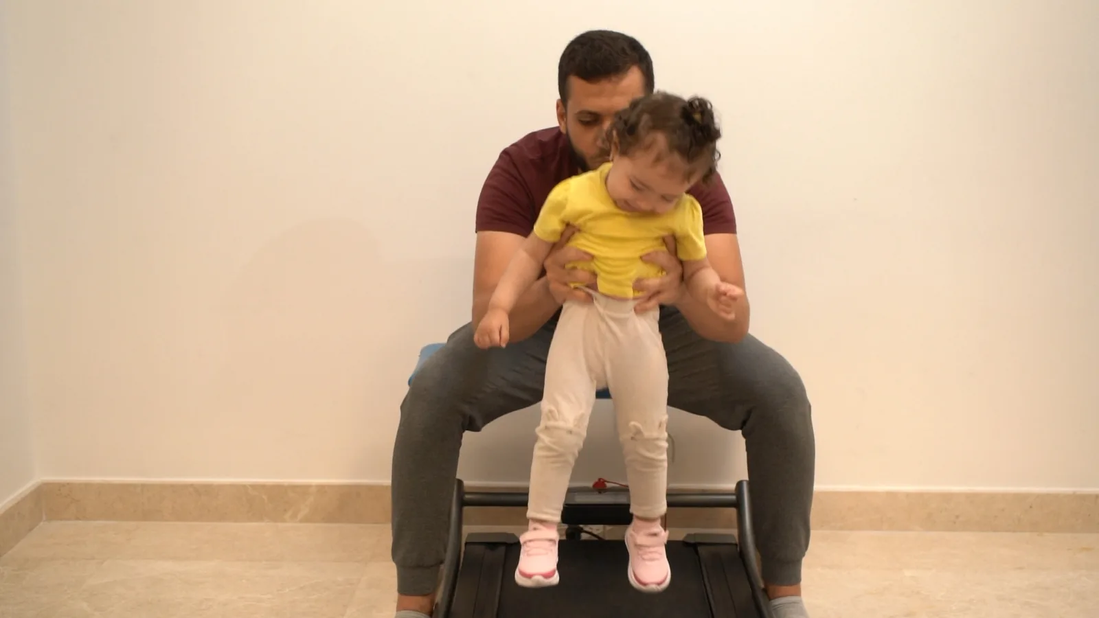 A therapist supports a child during a movement session
