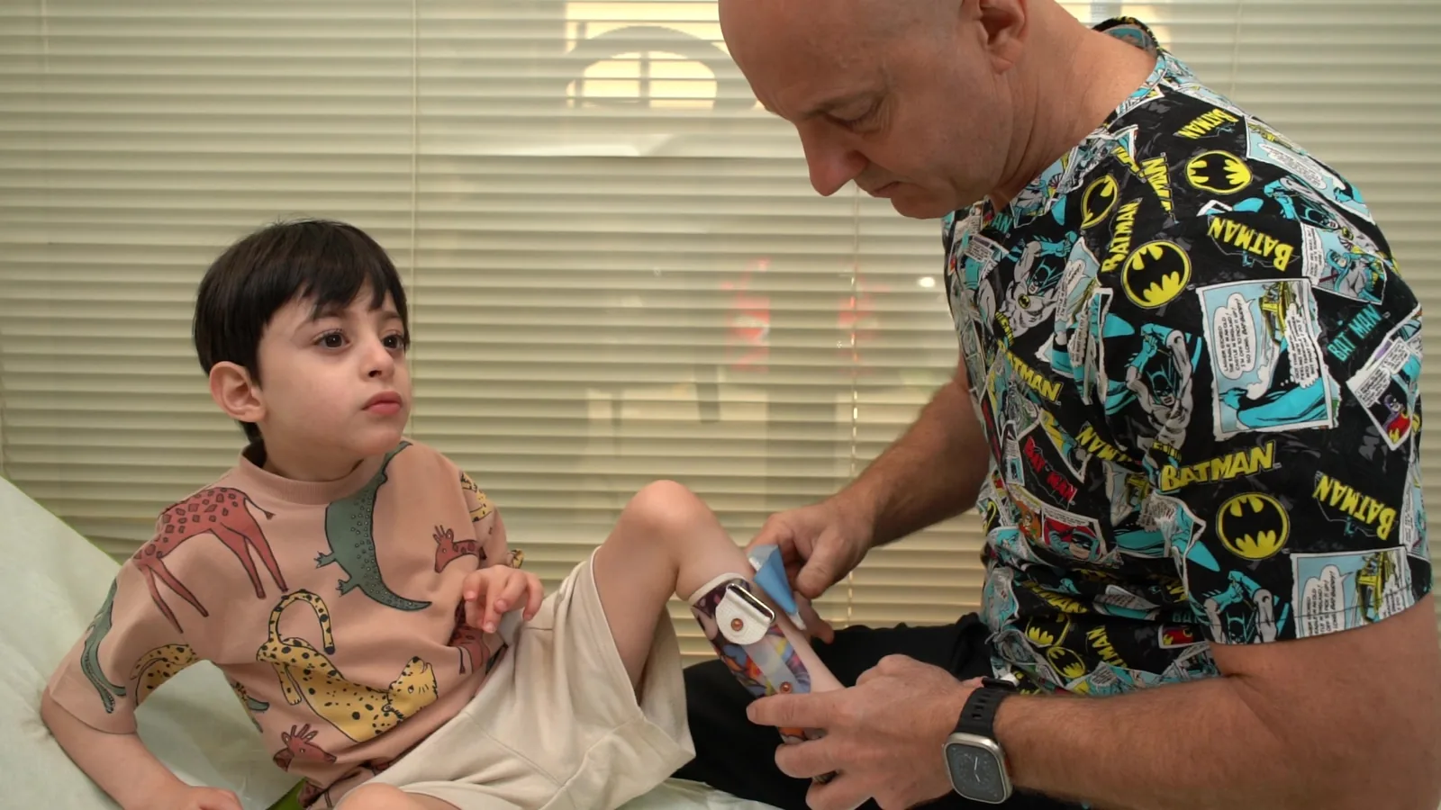 A practitioner fits an orthotic device for a child
