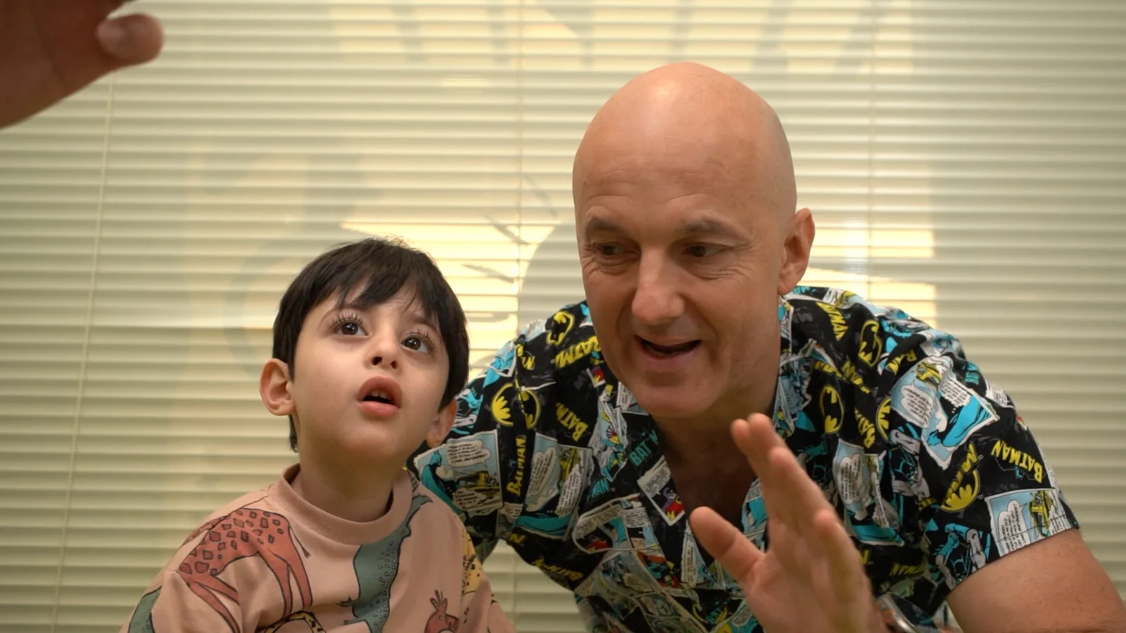 A Hope specialist waving to a young boy during a session
